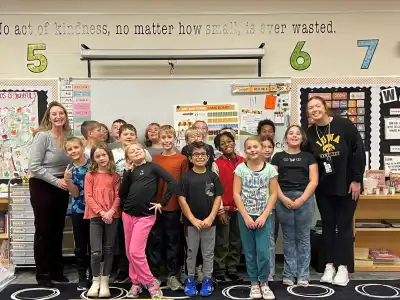 A group of students and their volunteer